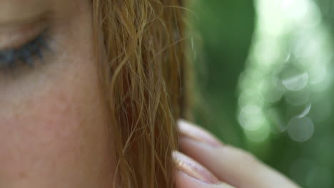 beautiful model with flower in her hair is standing in tropical scenery