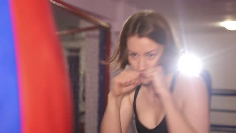 girl boxer practices punches professional womens boxing athletic woman practicing punches while training in the gym womens martial arts