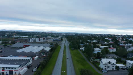 Aerial-drone-view-of-Reykjavik,-Iceland-capital-city-with-traffic-streets-and-colorful-rooftops.-Birds-eye-panoramic-view-of-the-northernmost-capital-city-in-the-world