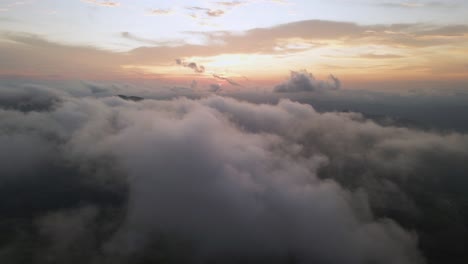 fluffy white clouds with colorful sunset, 4k drone over costa rica