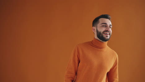 happy man in orange sweater