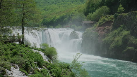 a waterfall of a pure wild river located in a green rainforest