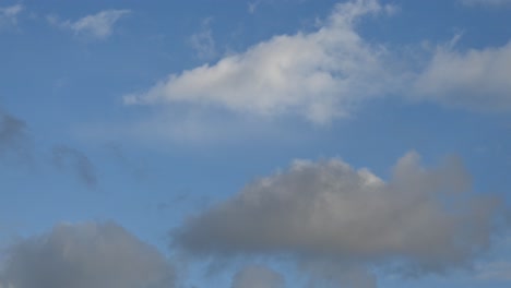 timelapse of moody clouds moving across a blue sky