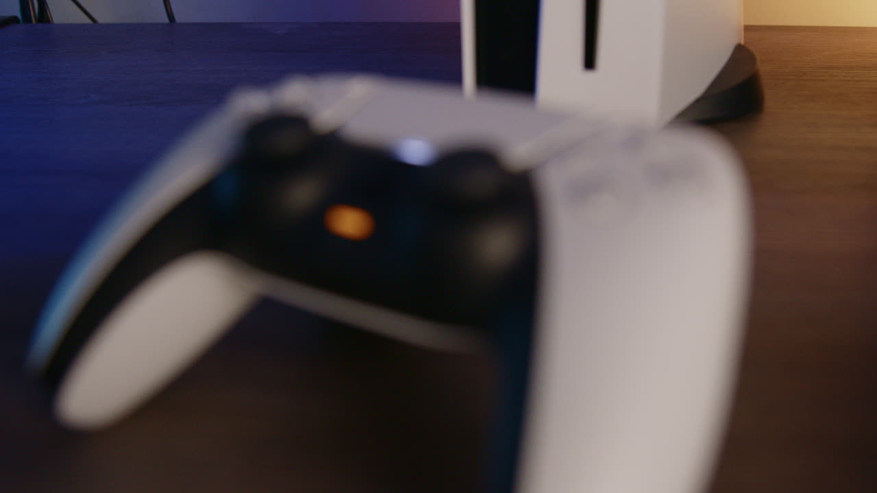 controlador ps5 en una habitación con led rgb por la noche, enfocando lentamente el medio