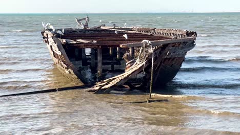 old shipwreck stranded on pattaya's sandy shore