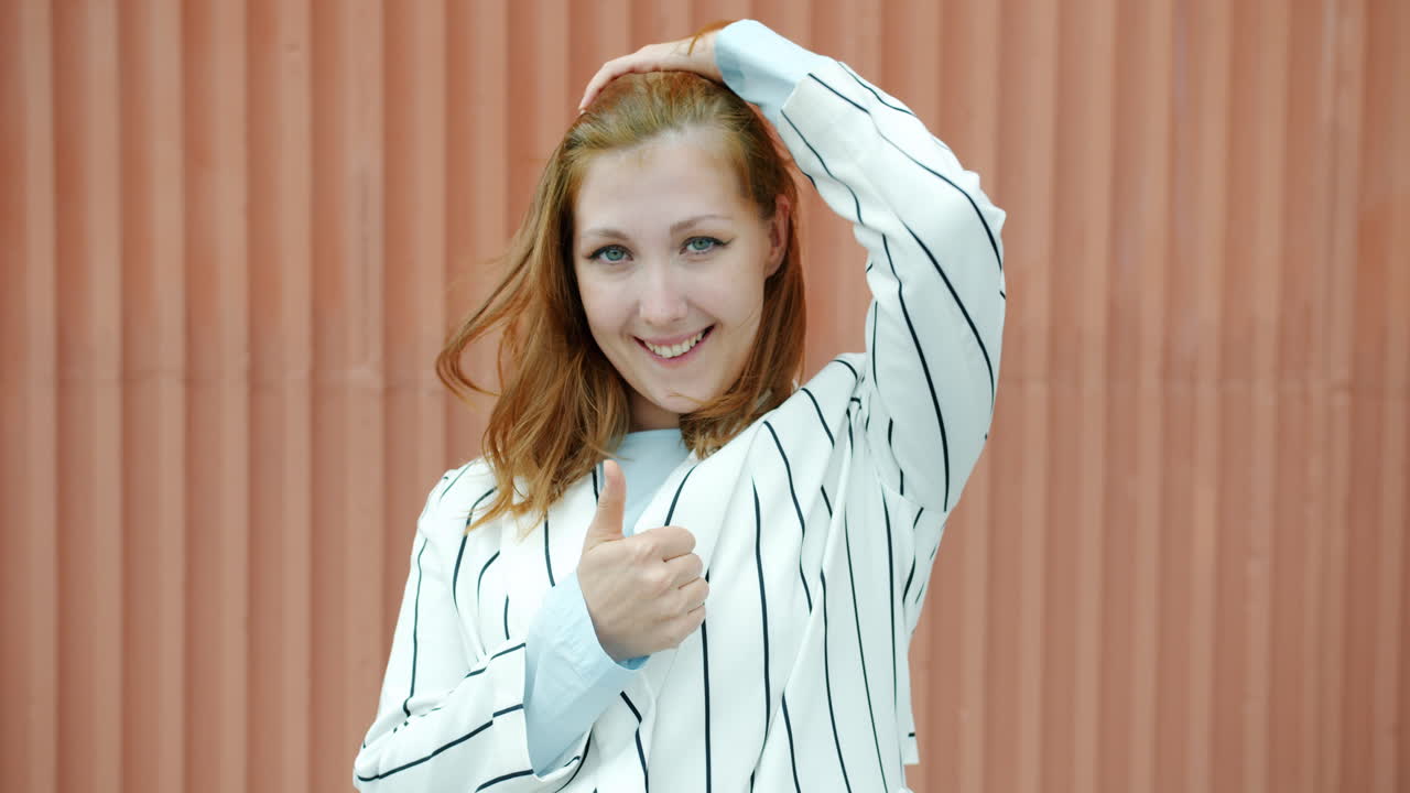 행복한 사업가 여성은 엄지손가락을 올립니다.