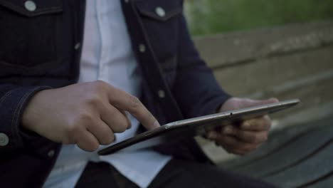 cropped shot of man using digital tablet outdoor