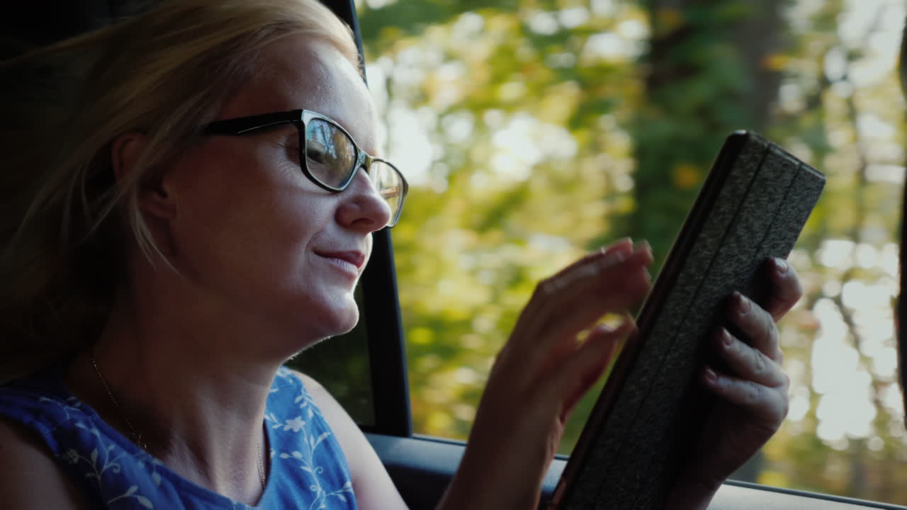 Woman Using Tablet in Car
