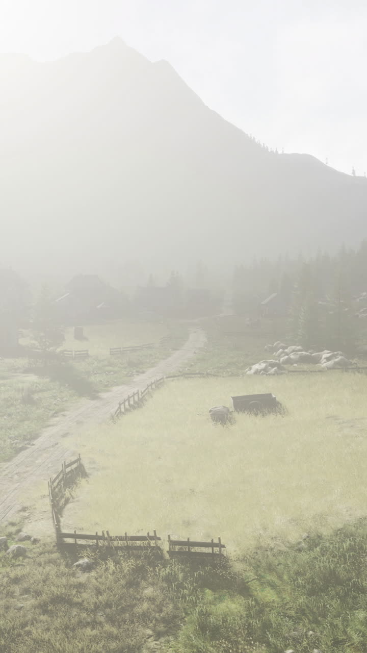 Scenic mountain landscape with a dirt path and rustic cabin at sunrise