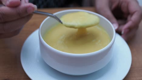 person eating creamy soup