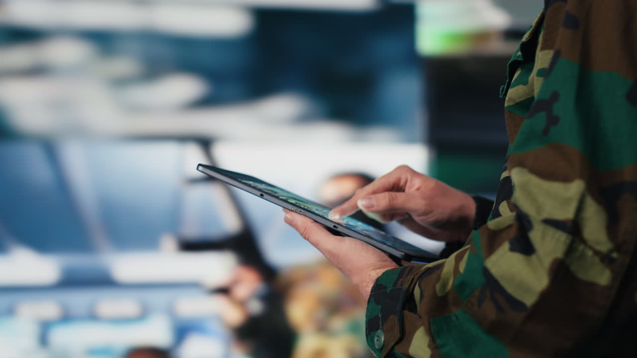 Defense forces officer reviews surveillance and digital systems