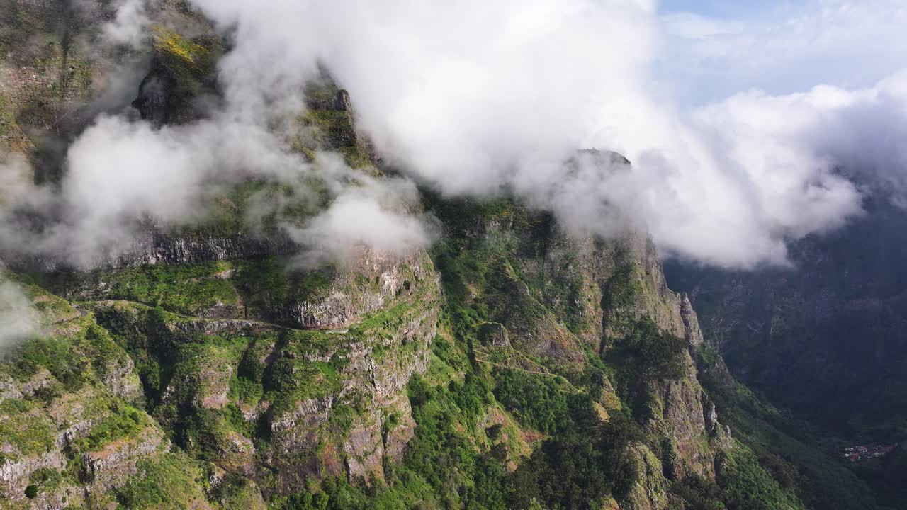 Curral das Freiras dramatic mountainside surrounded by eerie mountain fog, drone
