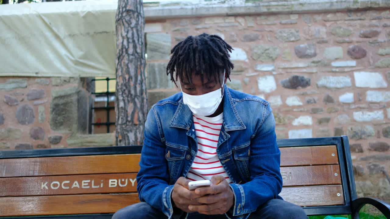 Black man with mask chatting