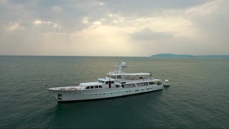 Tranquil-drone-shot-towards-a-white-luxury-yacht-on-the-calm-ocean