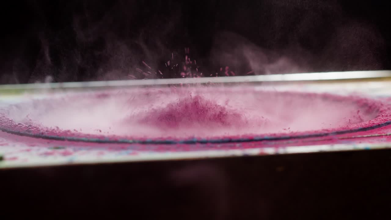 Polvere rosa che vibra e danza su un cono dell'altoparlante