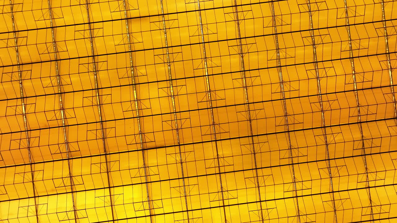 Close-up view of a golden circuit board or microchip wafer