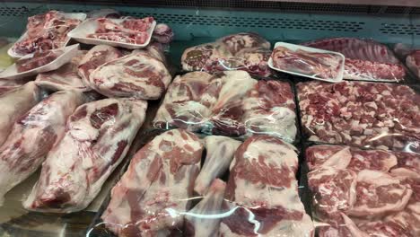 raw lamb and goat meat display in a grocery store