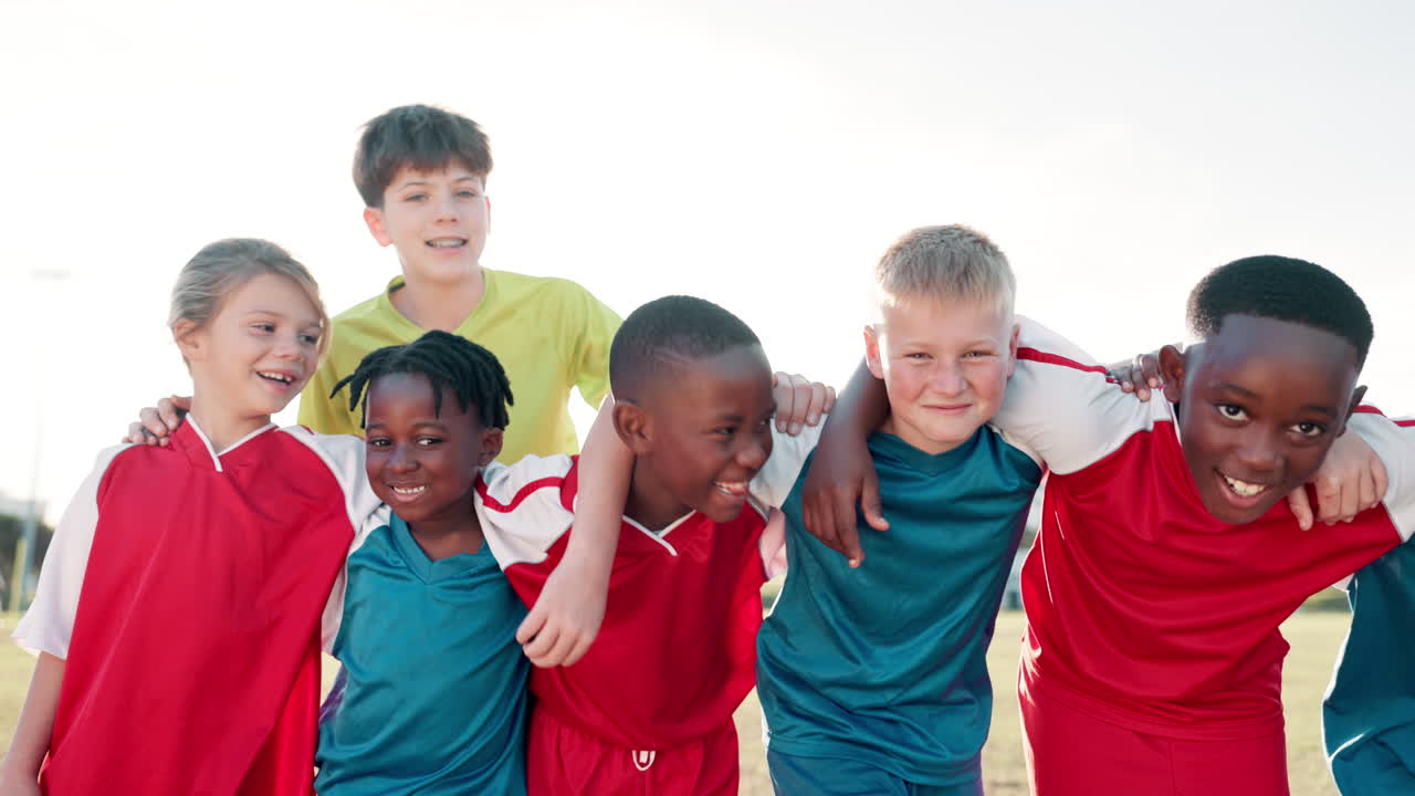 Diverse group of children in soccer uniforms celebrating teamwork