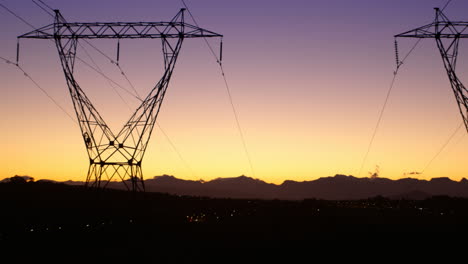 electricity pylons during sunset 4k