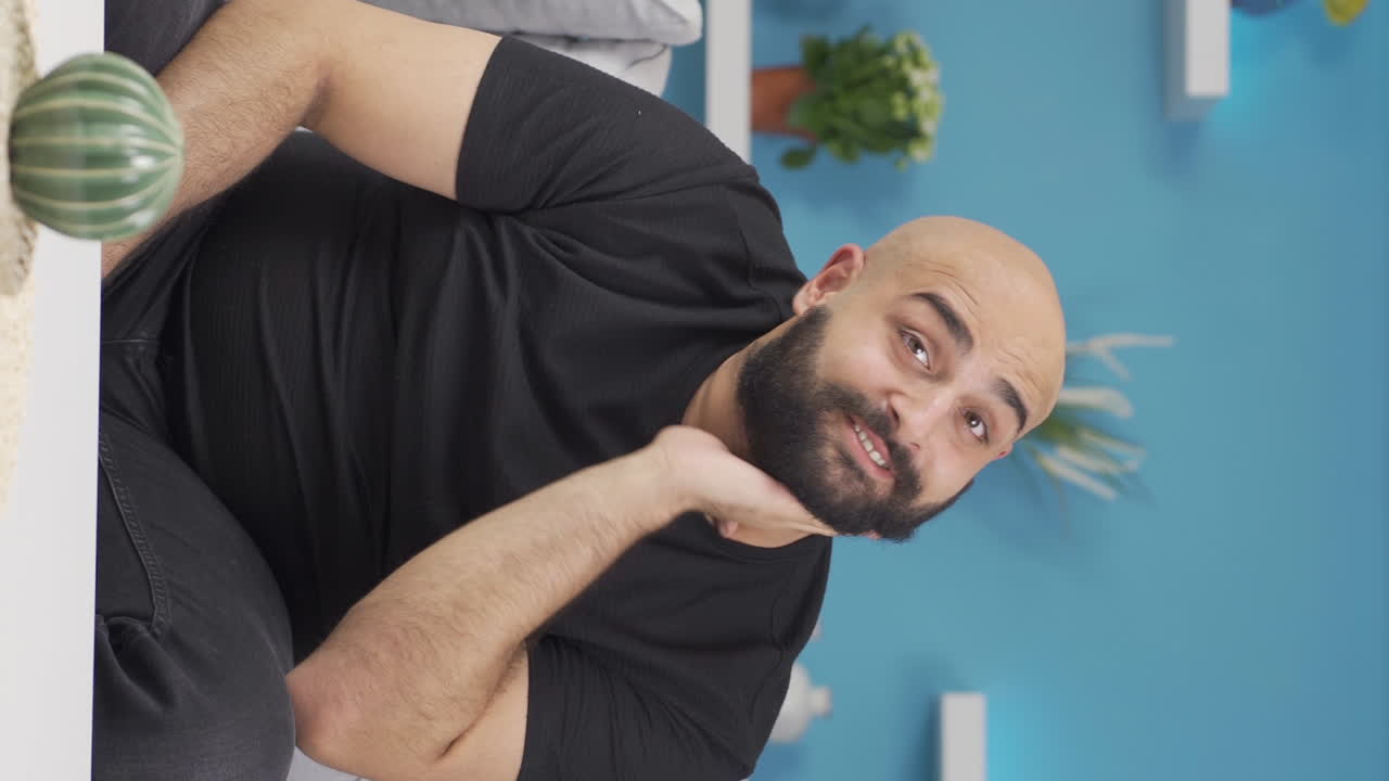 Vertical video of Positive man happy and smiling.