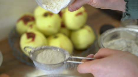 The-woman-sprinkles-the-flour-through-the-strainer