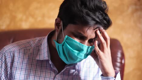 man experiencing headache while wearing a mask