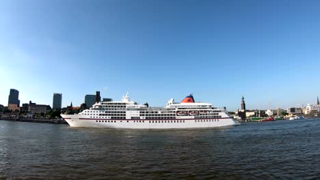 cruise liner in hamburg on departure, elbe and cityscape,