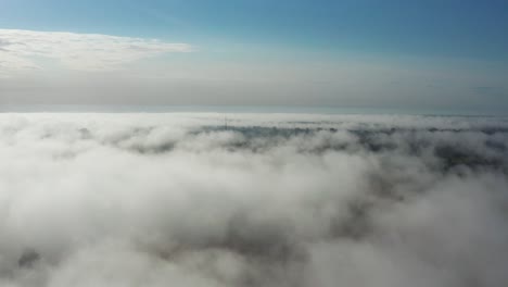 Scenic-aerial-view-above-dense-white-clouds-during-morning-sunrise,-Latvia