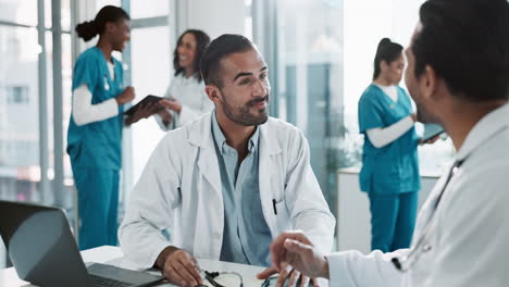 two doctors discussing a patient's case in an office