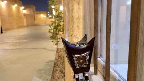 arabian bakhoor incense burner censer with smoke and blurred background of old city down town in doha qatar al wakrah souq with gold luxurious lighting renovation houses to visit at night walk family