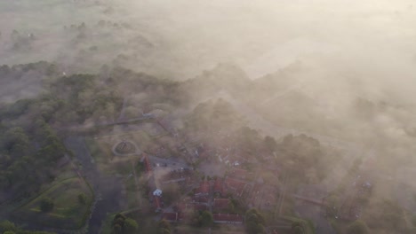 Reveal-shot-of-star-shaped-Fort-Bourtange-Groningen-during-foggy-morning,-aerial