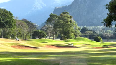 scenic golf course with mountains in the background