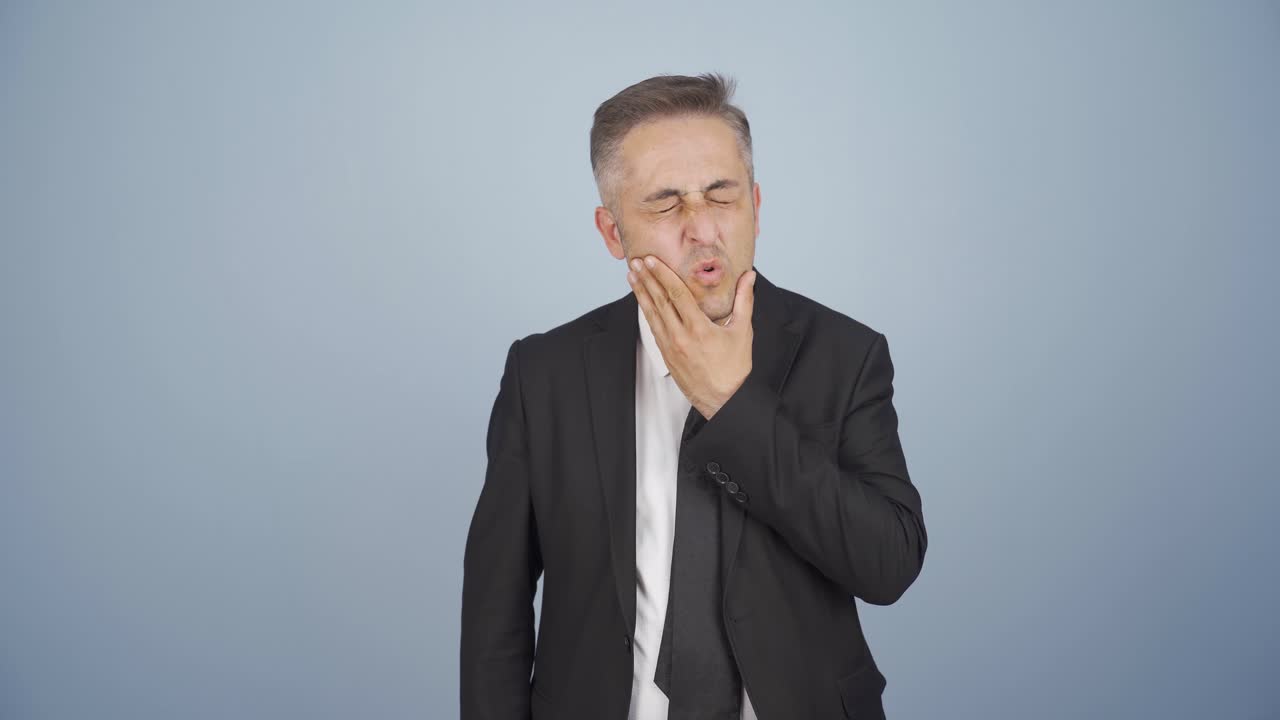 Businessman suffering from toothache.