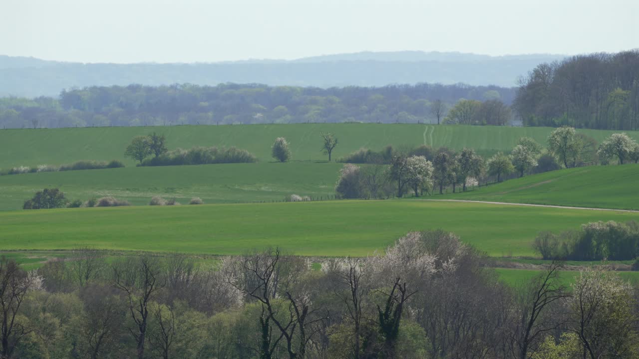Rural French countryside rolling green fields and distant hills France landscape