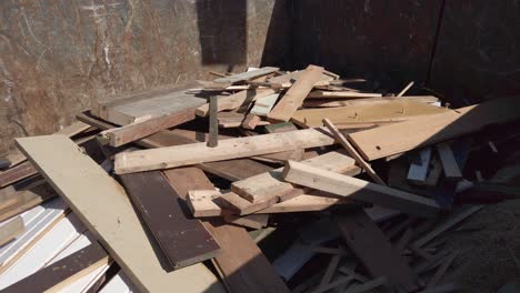 old wooden boards falling into container, slow motion