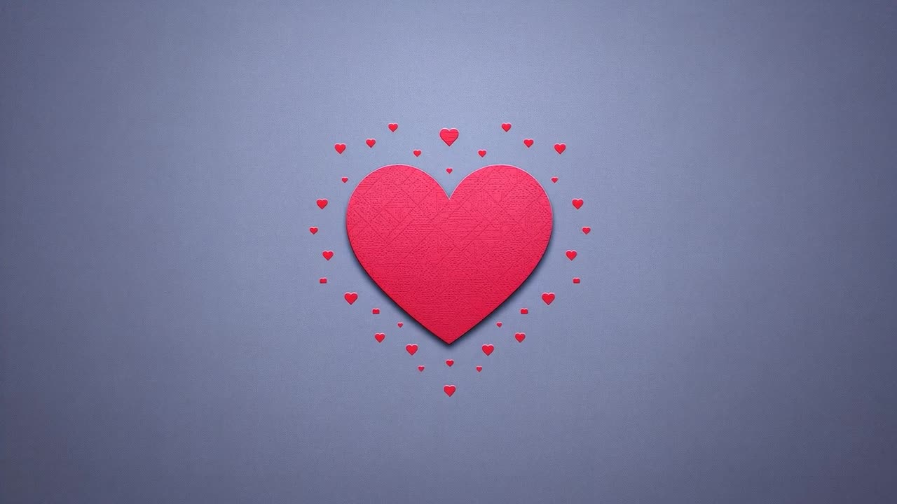 La camera inquadra un grande cuore di carta che si espande su un tavolo da studio, creando un effetto visivo con ombre e piccoli cuori