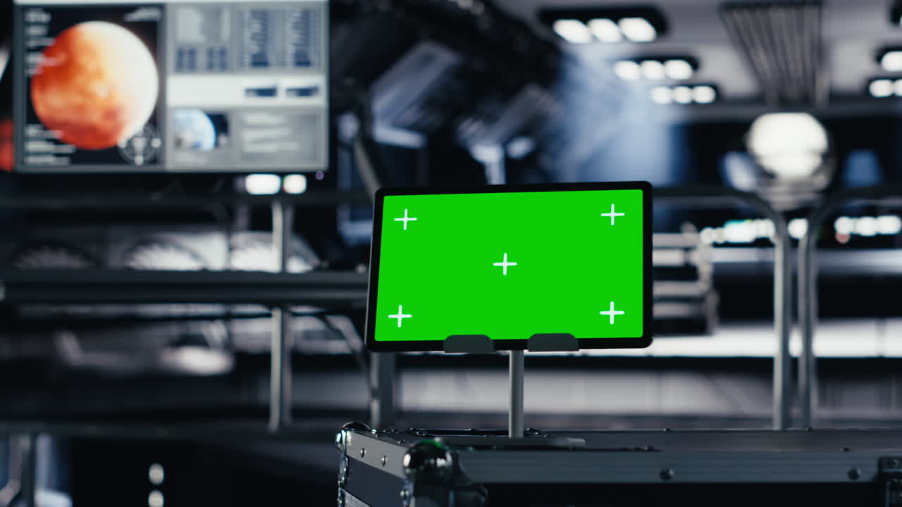 Chroma key tablet in orbital station surrounded by high tech gear