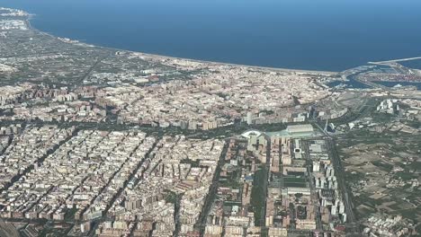 aerial view of valencia city, spain, shot from an airplane cockpit during the departure in a splendid summer day