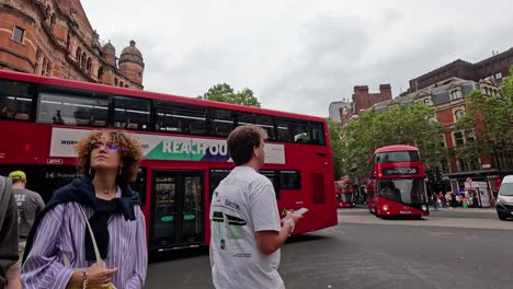 people and vehicles on a bustling london street