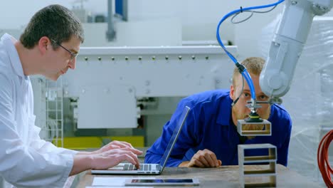 robotic engineers examine robotic machine in warehouse 4k