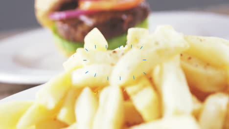 animation of blue lines overlaying burger and fries on plate