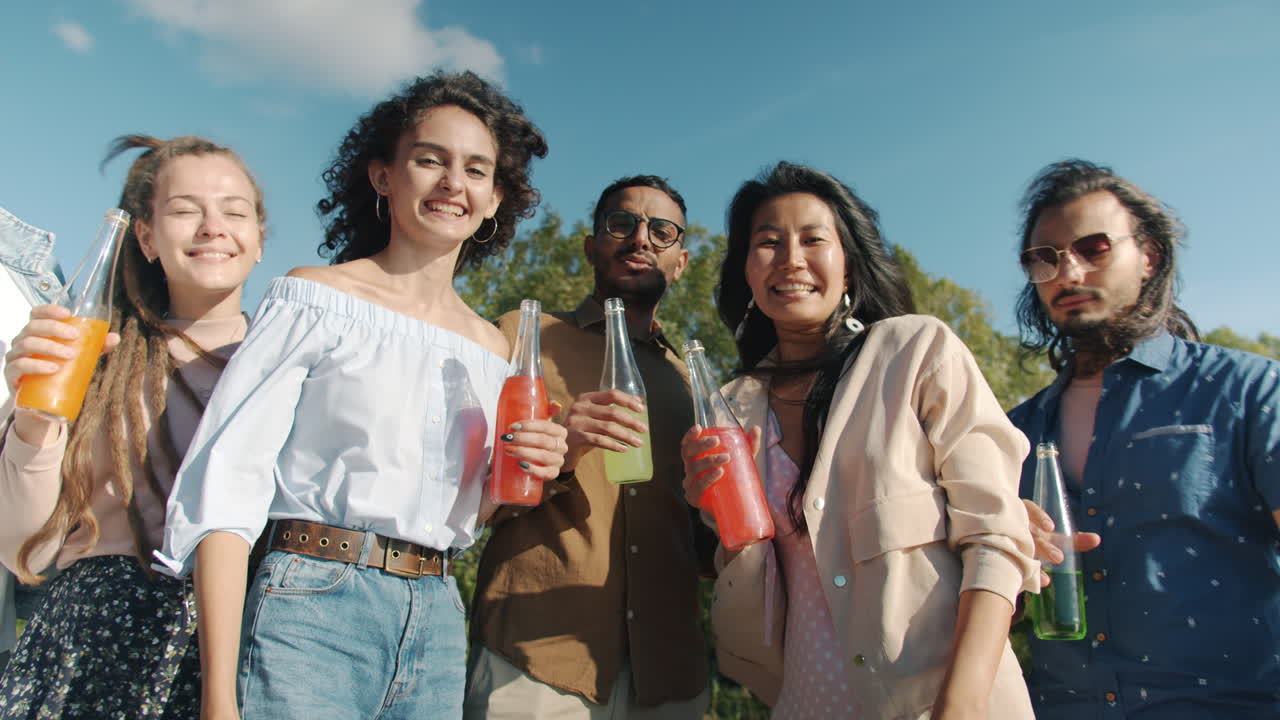 Friends enjoying drinks outdoors on a sunny day