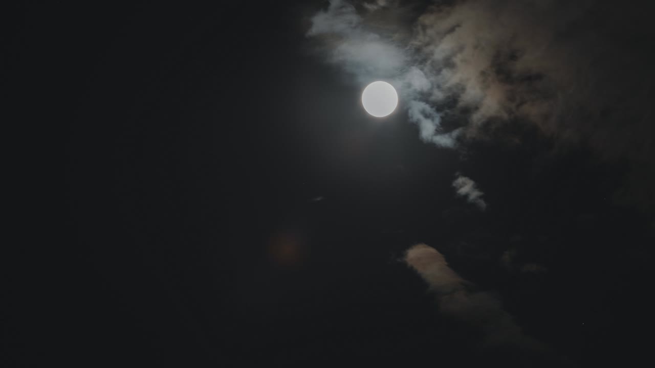 구름과 함께 어두운 하늘에서 떠오르는 슈퍼 보름달의 시간 경과.