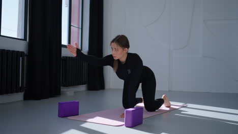 woman practicing yoga in a studio