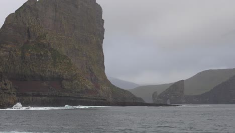 close up shot of the north atlantic ocean waves in front of tindholmur