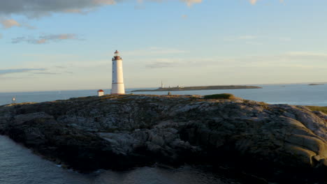 lille torungen lighthouse - coastal lighthouse on the island of lille torungen, arendal, agder county, norway - aerial drone shot