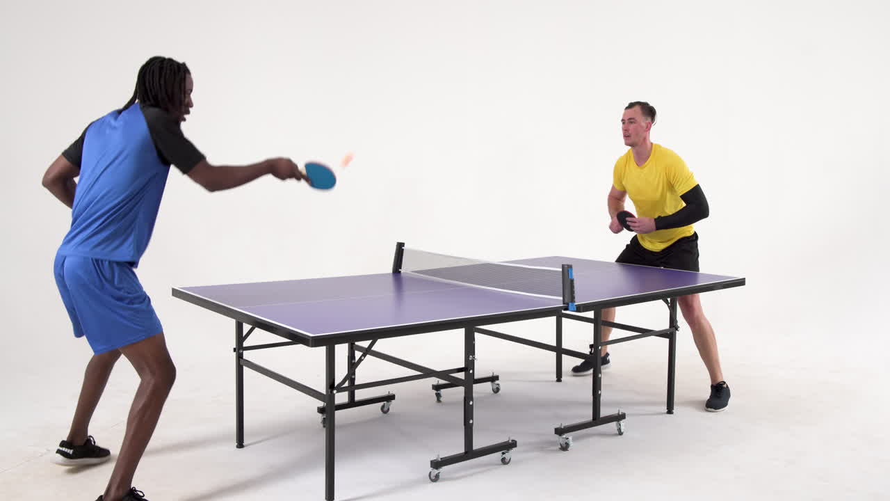Multiracial male table tennis players, serving and passing the ball on white background