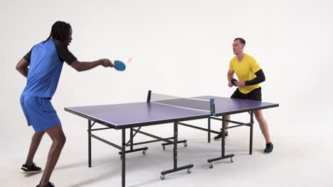 multiracial male table tennis players, serving and passing the ball on white background