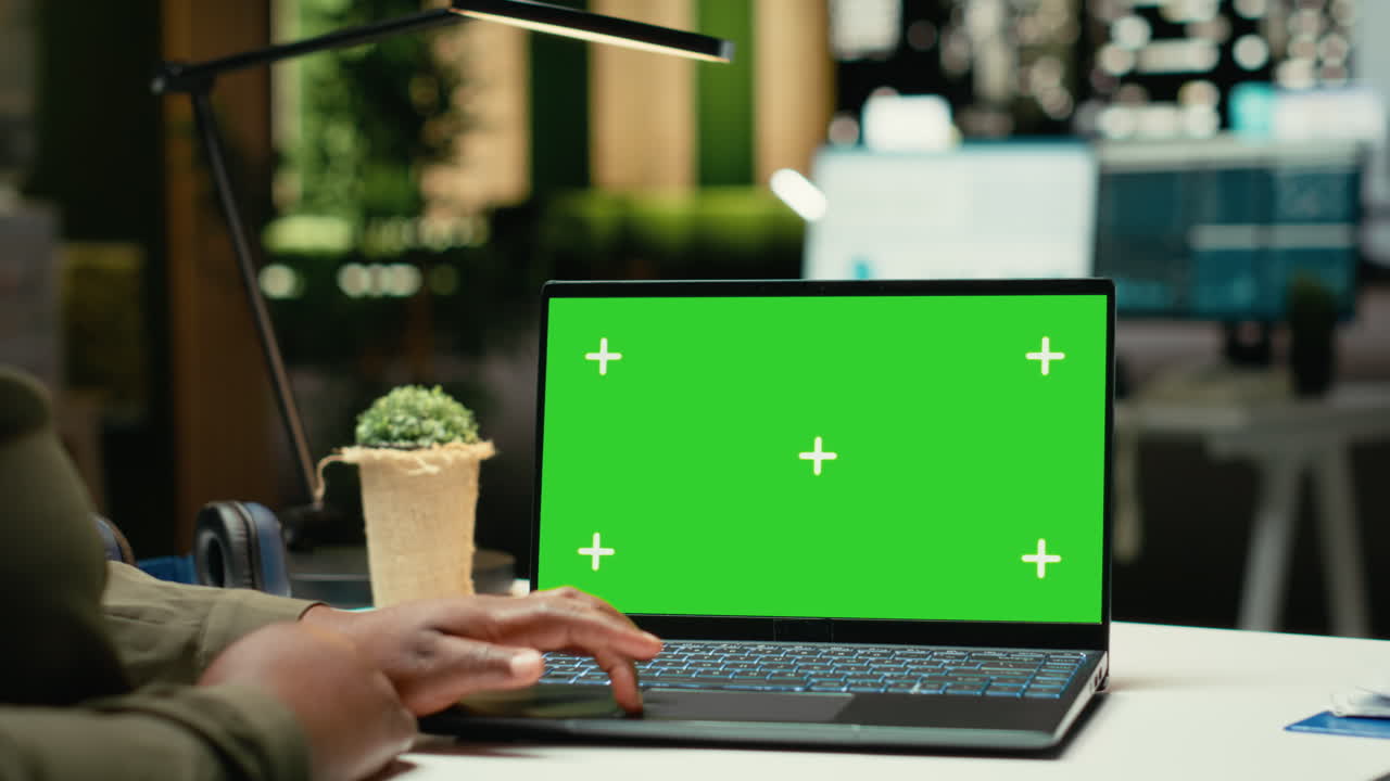 Green screen on gadget where young black specialist finishing management tasks