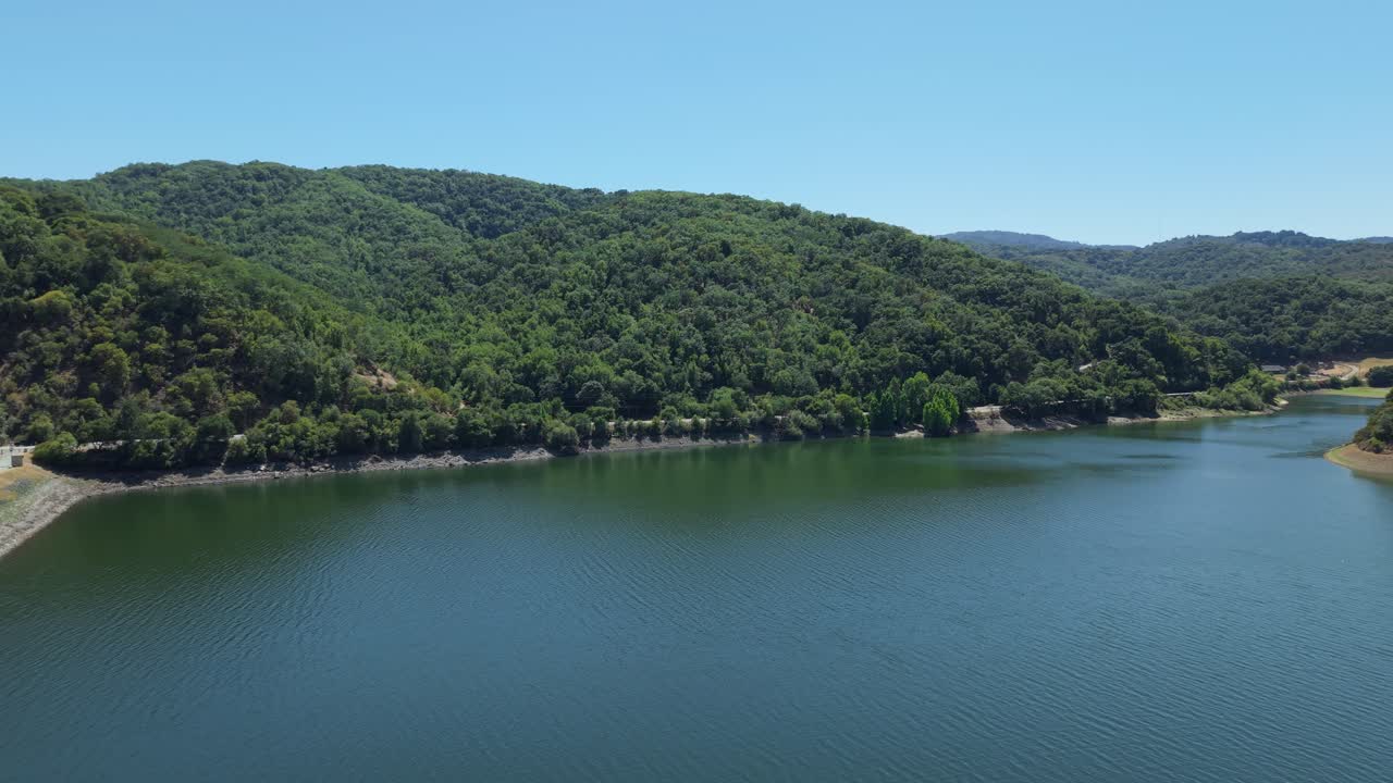 A left to right aerial pan reveals the clean lines of Uvas Reservoir carving through the serene California foothills